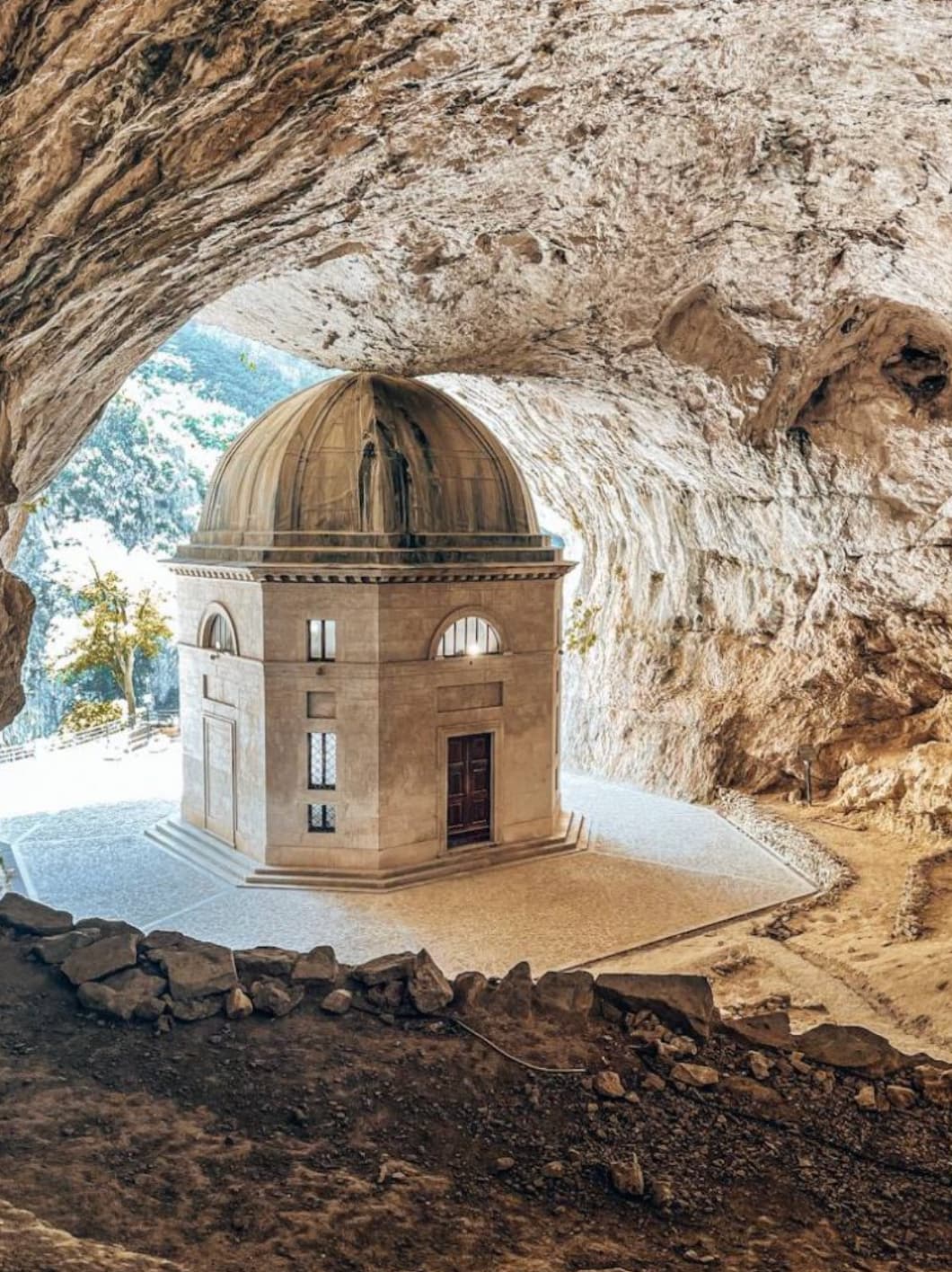 “Temple of Valadier, Italy. Located at the entrance of the Frasassi Caves, this ancient sanctuary, first mentioned in documents from 1029, is a simple stone structure built by Benedictine monks to house a revered image of the Madonna.”